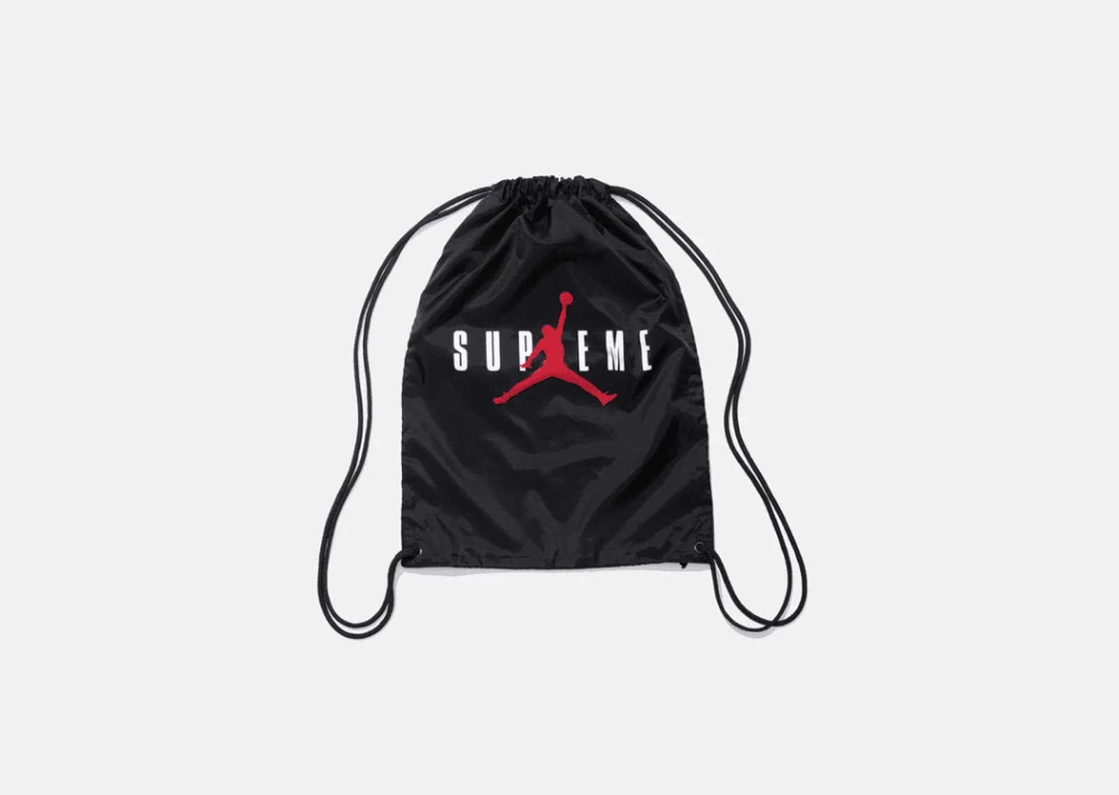 Black drawstring backpack with a red silhouette of a basketball player dunking and the word 'SUPREME' printed in white across the front.