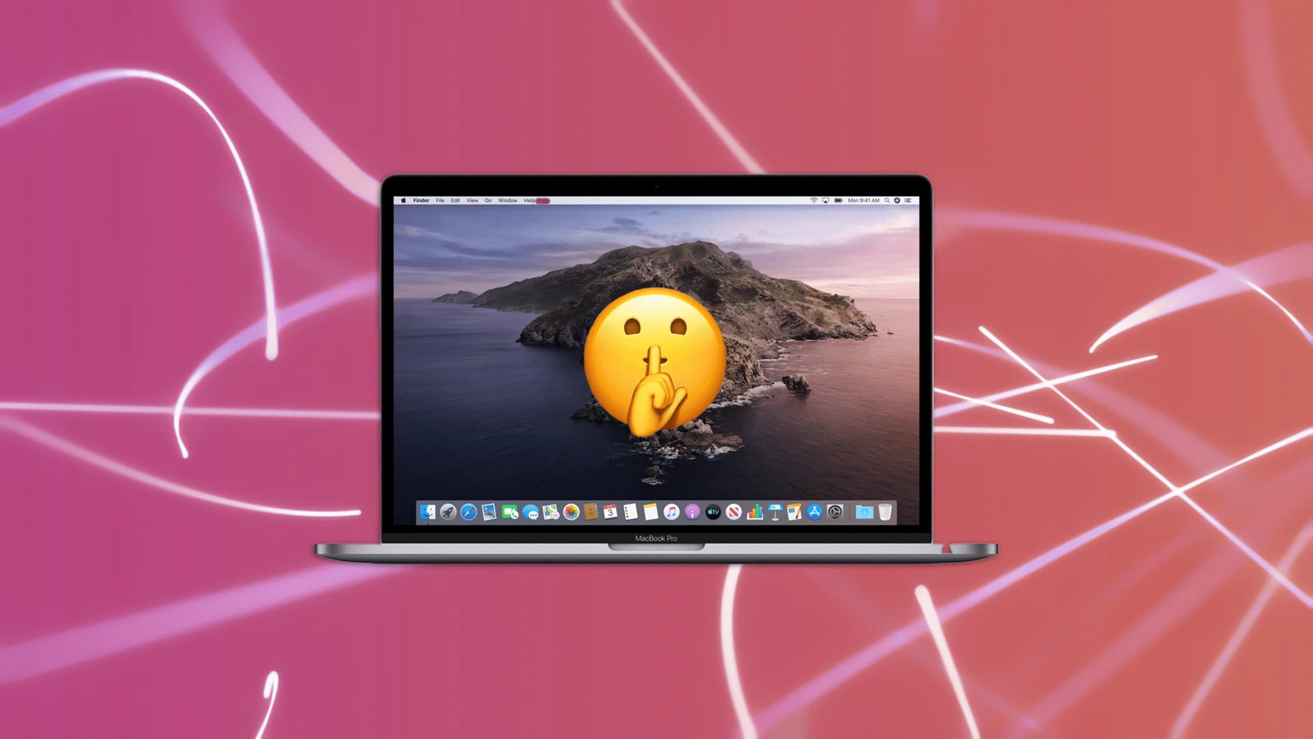 A MacBook Pro laptop displaying a mountain landscape wallpaper and a large shushing emoji on the screen, set against a pink background with abstract white lines.