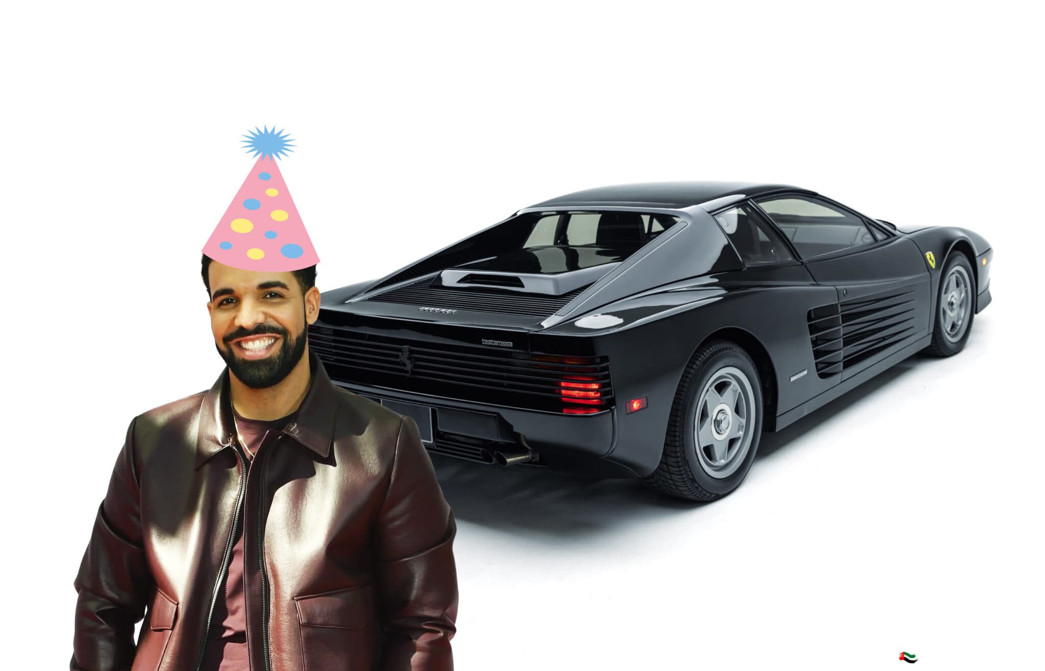 Smiling man in a party hat standing beside a black Ferrari Testarossa