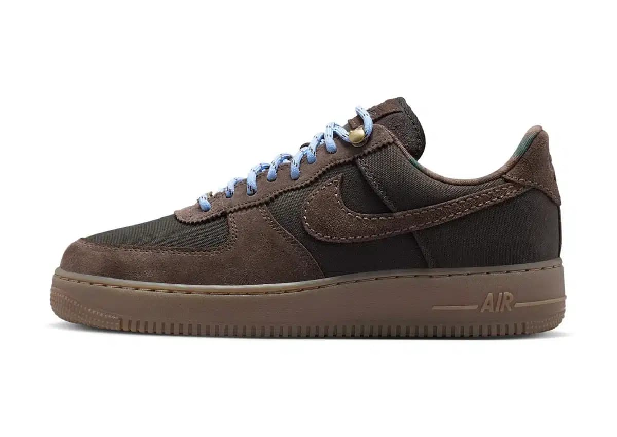 Brown and black Nike Air low-top sneaker with light blue laces and a gum-colored sole