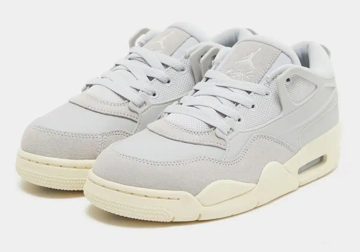 Pair of light gray sneakers with white accents and cream-colored soles, featuring a mix of mesh and suede materials.