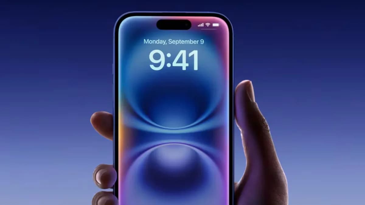 A hand holding a smartphone with a blue and purple abstract wallpaper, displaying the time 9:41 and the date Monday, September 9, against a dark blue background.