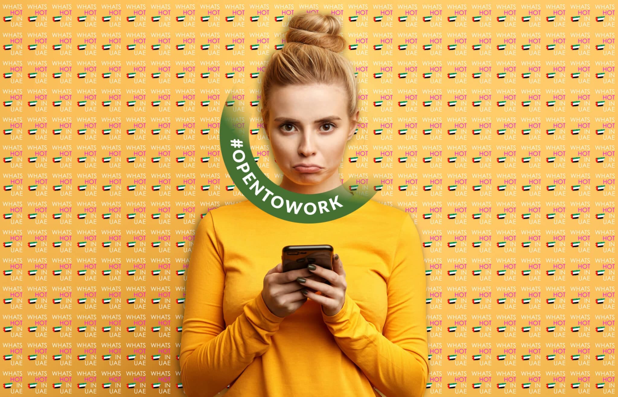 A person with a bun hairstyle wears a yellow long-sleeve shirt and holds a smartphone, standing in front of a backdrop with repeated patterns of UAE flags and text saying, "WHAT'S HOT IN UAE." A circular graphic with the hashtag "#OPENTOWORK" is overlaid on the image.