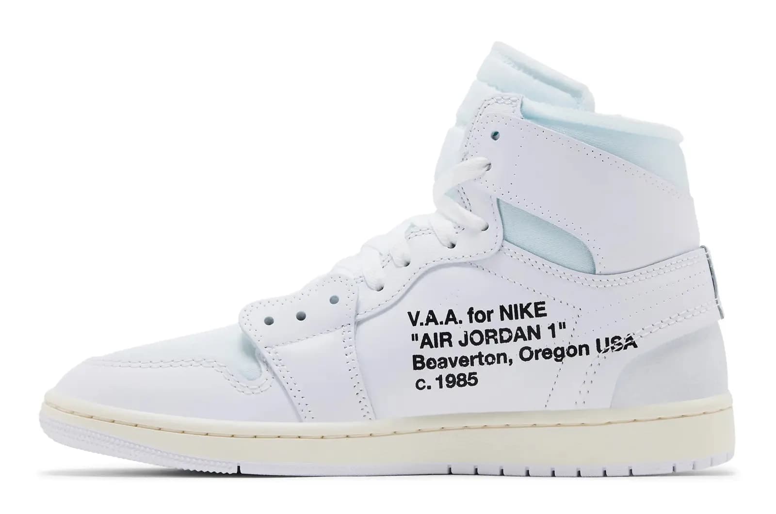 A white high-top sneaker featuring the text "V.A.A. for NIKE 'AIR JORDAN 1' Beaverton, Oregon USA c. 1985" on its side.