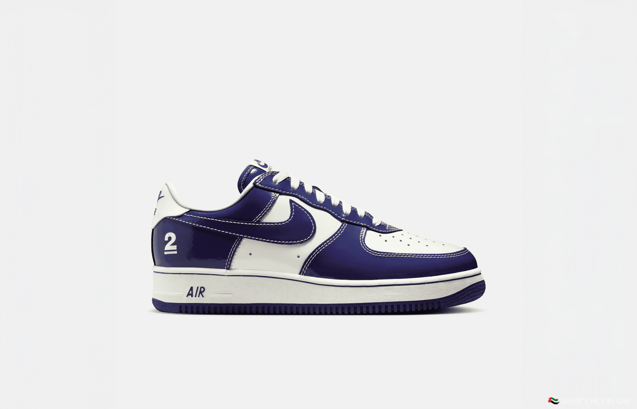 A white and purple sneaker with the number 2 on the heel and "AIR" on the midsole.