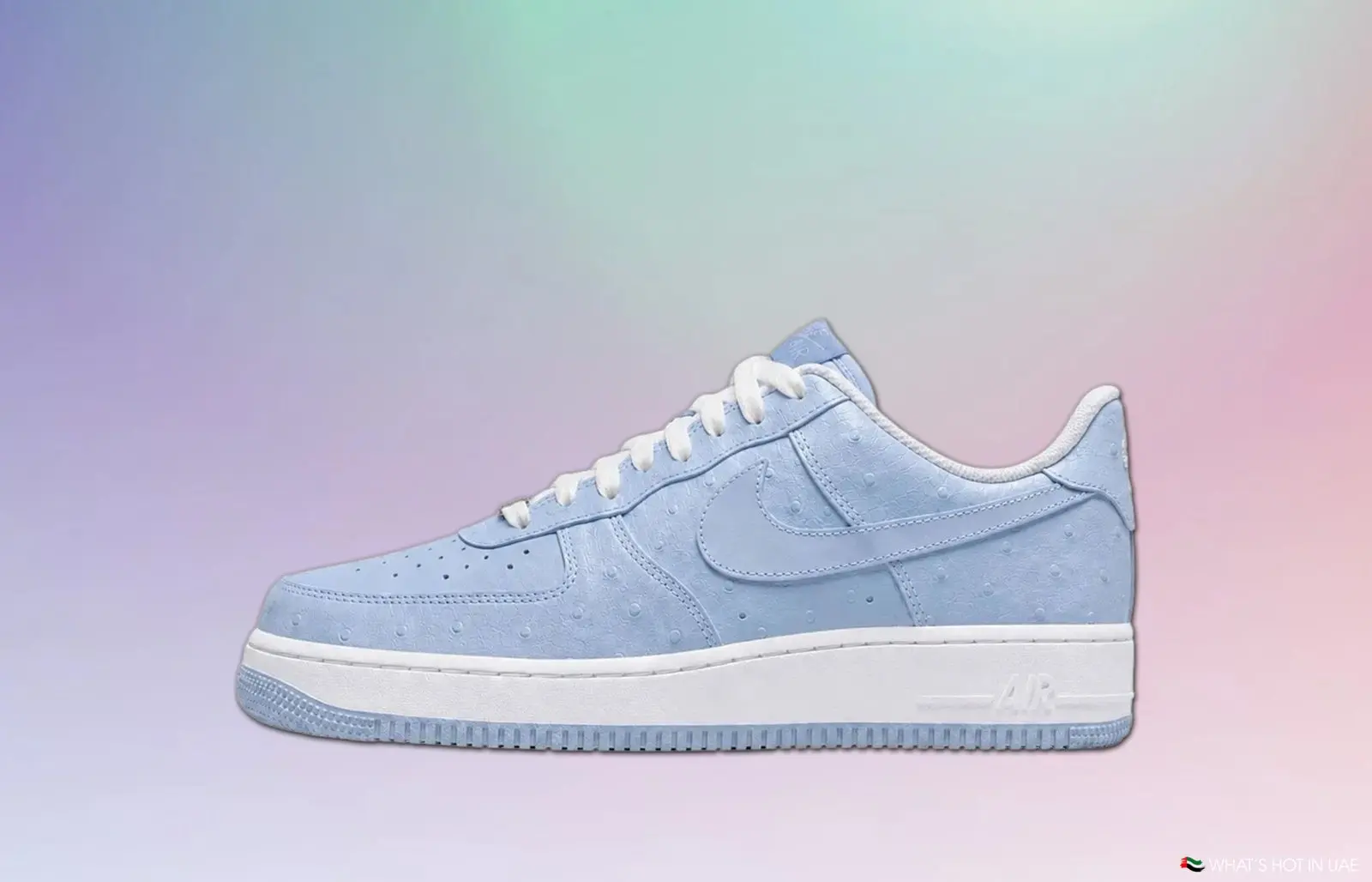 Light blue Nike Air Force 1 sneaker on a pastel gradient background