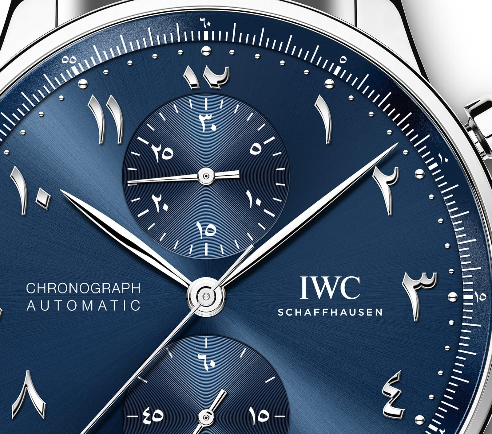 Close-up of a blue IWC Schaffhausen chronograph watch dial with Arabic numerals, subdials, and “Chronograph Automatic” text