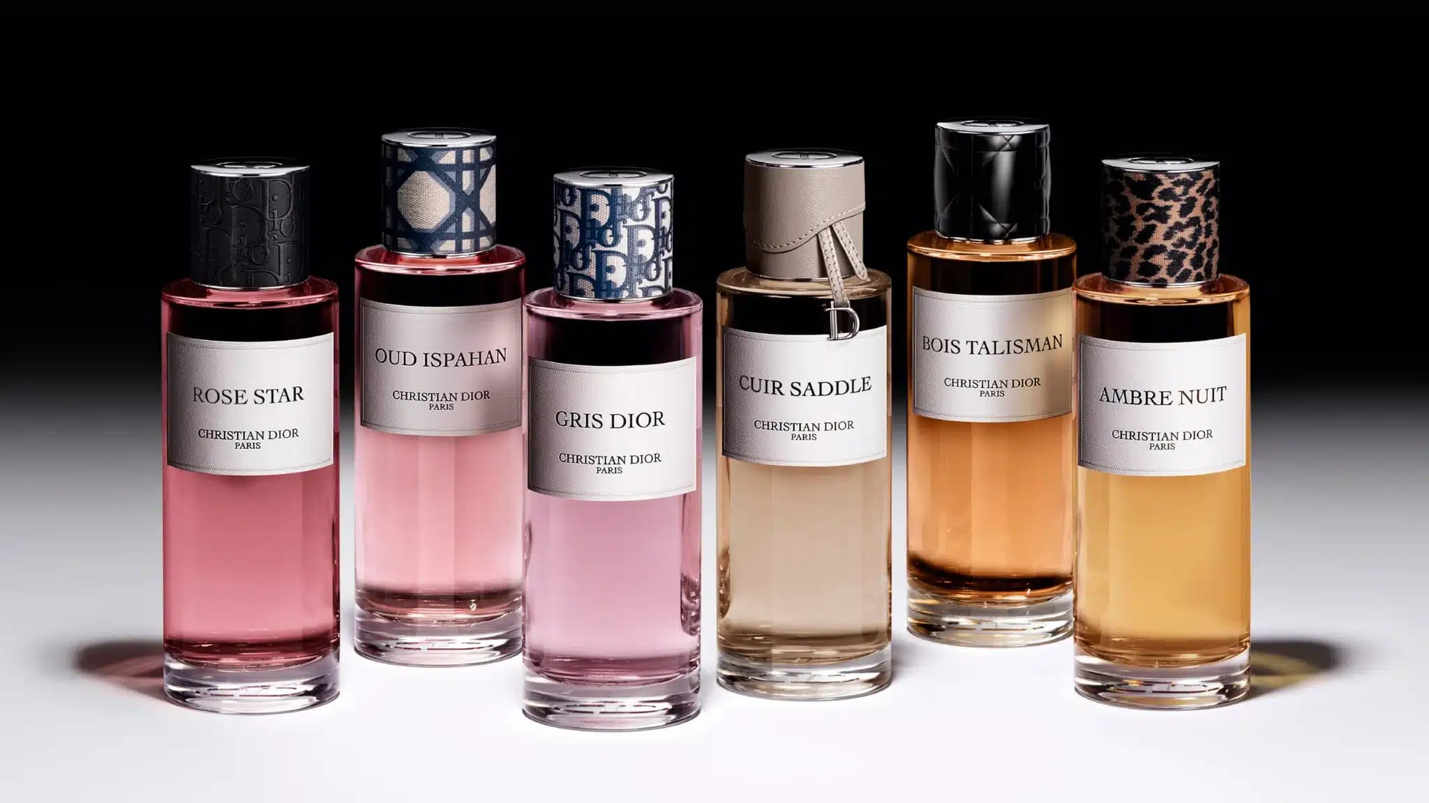 Six Christian Dior perfume bottles labeled Rose Star, Oud Ispahan, Gris Dior, Cuir Saddle, Bois Talisman, and Ambre Nuit