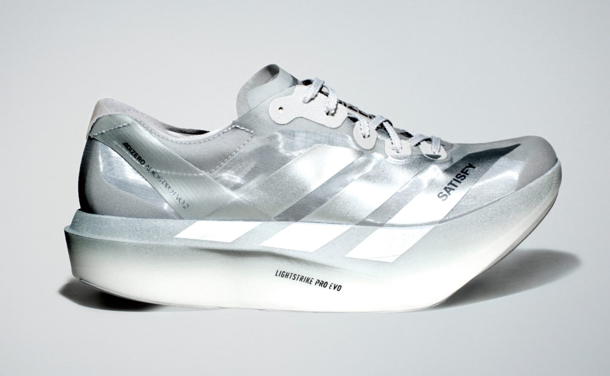 White Adidas Adizero Lightstrike Pro Evo running shoe with black stripes and “Lightstrike Pro Evo” branding