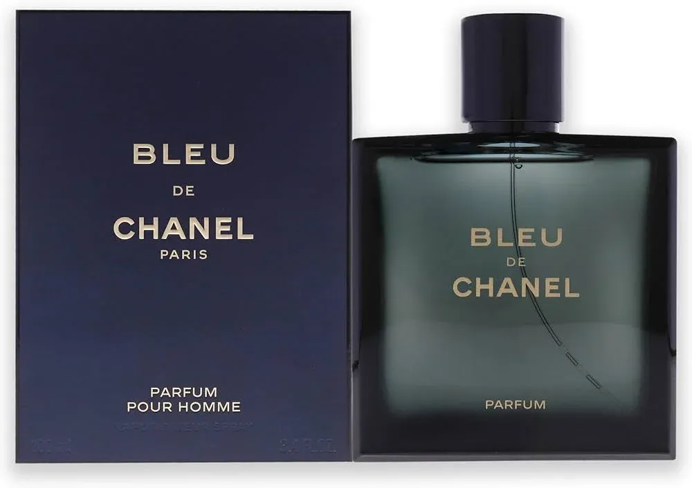 A bottle of Bleu de Chanel parfum for men alongside its dark blue packaging, featuring gold lettering on both the box and bottle.