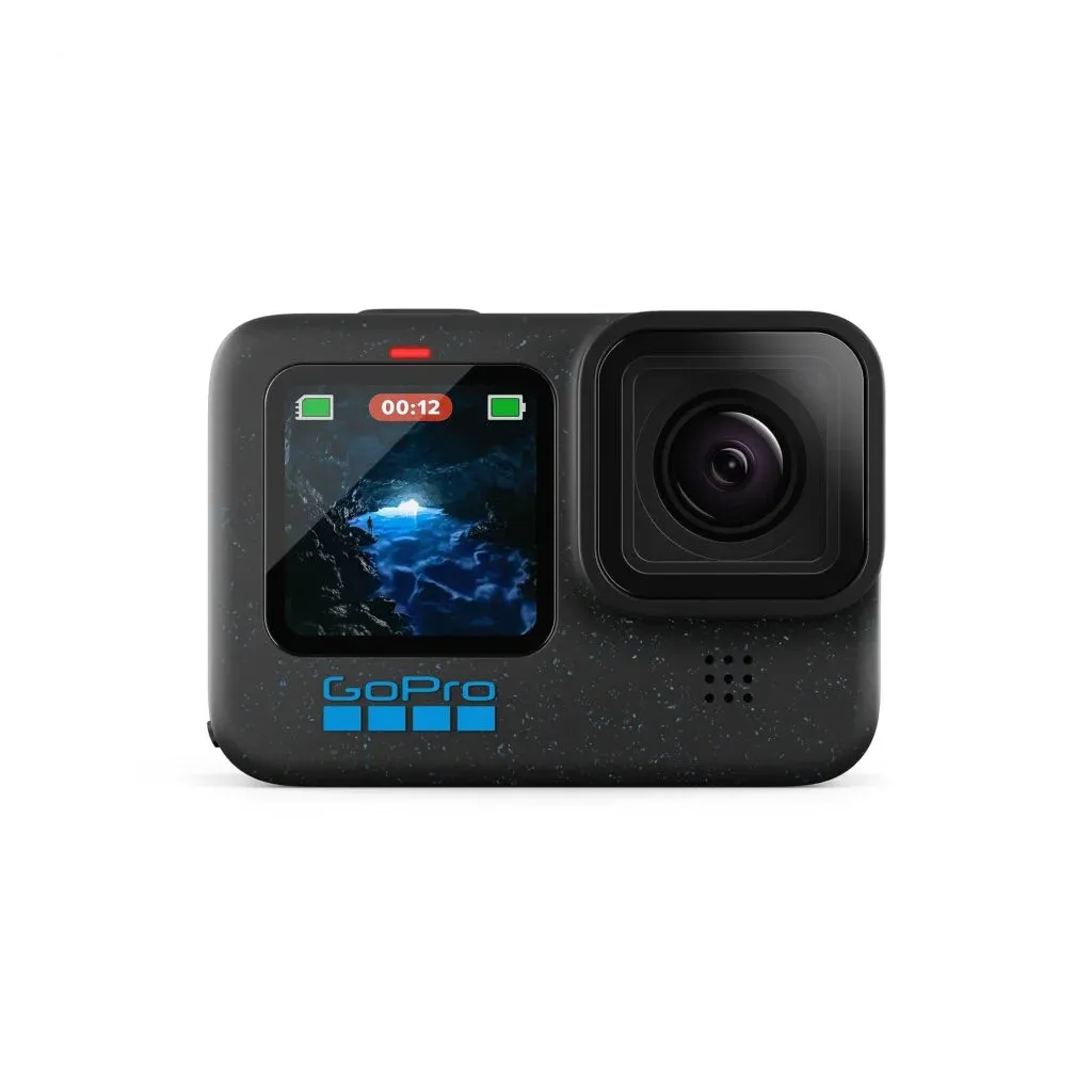 A GoPro camera with a small front display showing a cave scene and a recording indicator, alongside the main lens on a dark, speckled body.