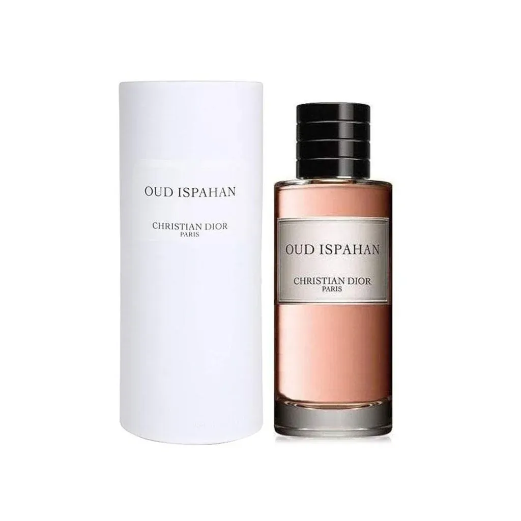 A bottle of Christian Dior's Oud Ispahan perfume next to its white cylindrical packaging.