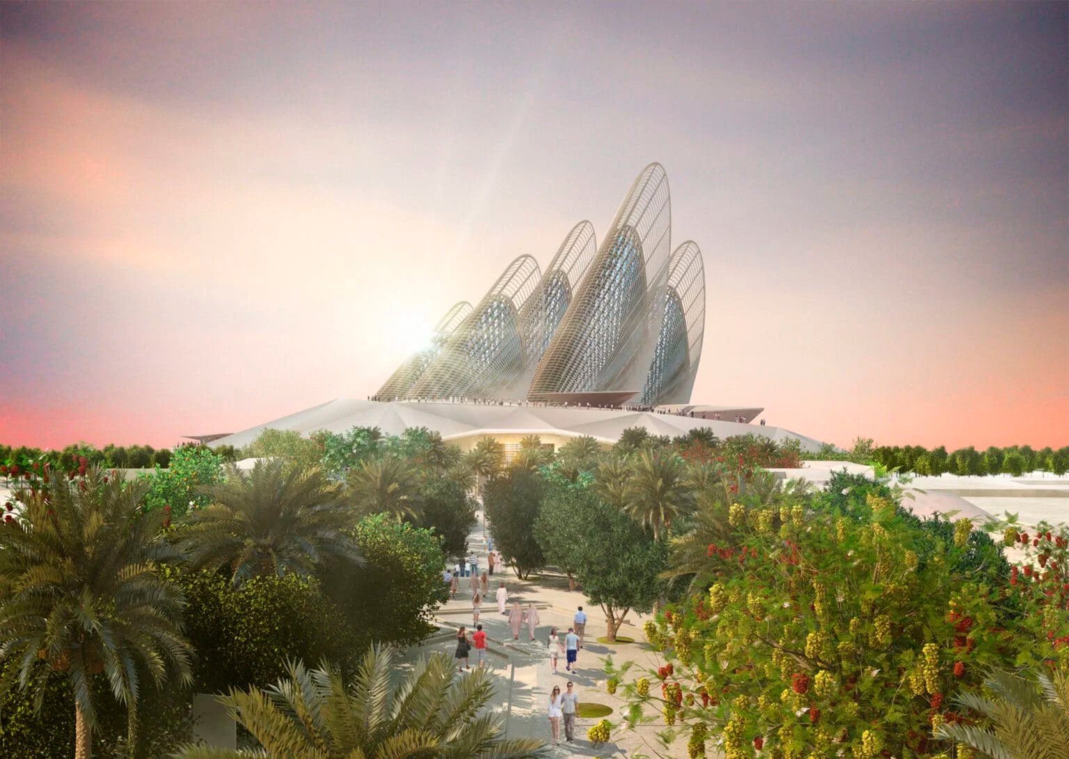 A futuristic architectural building with a series of curved, mesh-like structures towering over a landscaped garden with palm trees and people walking. The sky is lit with the warm colors of a sunset.