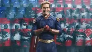 A person in a superhero costume stands confidently with gloved hands clasped, set against a backdrop of riot police with red and blue shields splattered with paint.