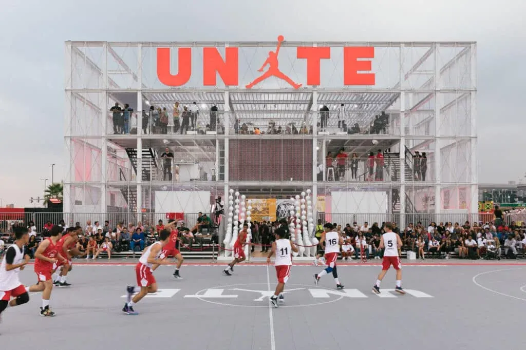Outdoor basketball game in front of a Sneaker Culture UAE structure with the large word
