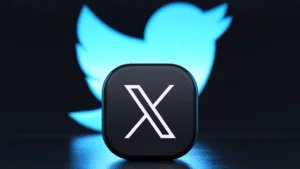 A black button with a stylized white letter 'X' in the foreground, with a blurred blue bird silhouette in the background.
