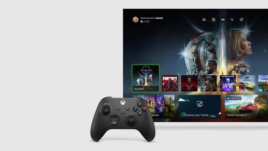 A black Xbox controller rests in front of a screen displaying the Xbox dashboard, featuring game titles like Starfield, Fortnite, and Diablo, with a Starfield promotional graphic in the background.