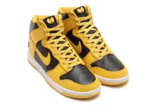 A pair of high-top sneakers in black and yellow with Nike logos and a distinctive logo on the tongue.