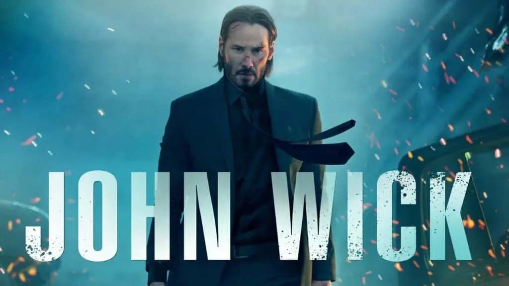 A man in a suit with a serious expression stands against a blue and smoky background with sparks flying around. The text