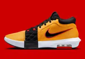 A yellow and black sneaker with a red and black Nike swoosh, featuring a white sole and visible air cushioning, set against a red background.