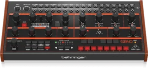 Close-up of a Behringer synthesizer control panel featuring various knobs, switches, and buttons with red and black colors, labeled with terms like OSC, FILTER, MODULATION, and SEQUENCER, indicating different functions for sound control and manipulation.