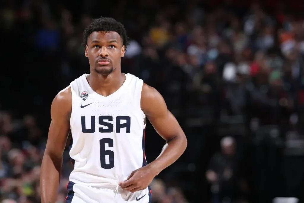 A basketball player wearing a white Team USA jersey with the number 6, standing on a basketball court with a focused expression.