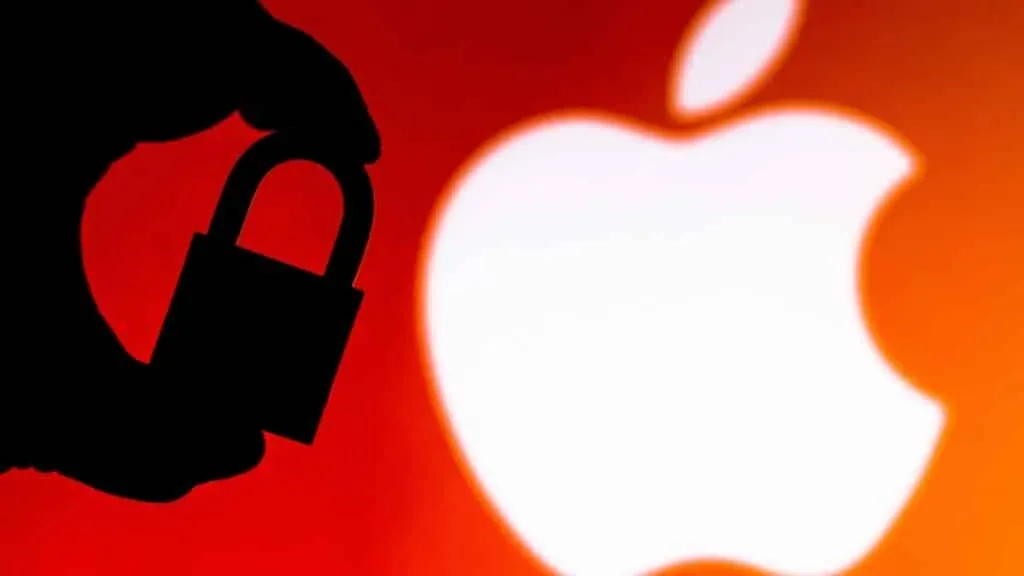 A silhouette of a hand holding a padlock in front of a large, blurred Apple logo on a red background.
