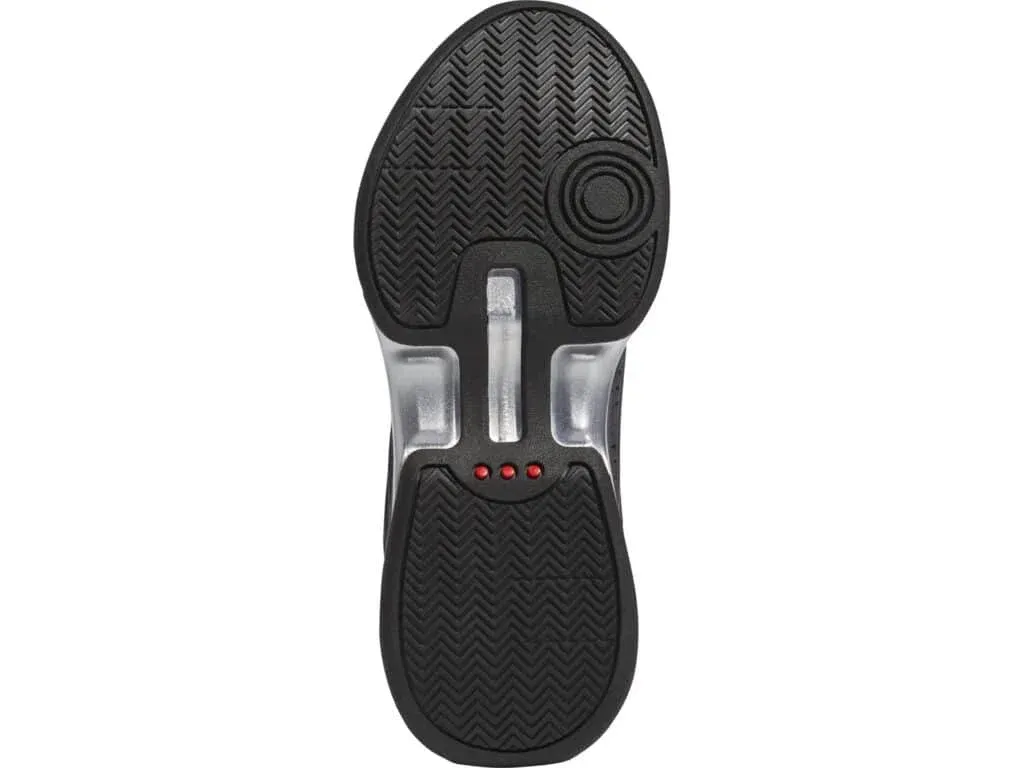 Sole of a black shoe with a herringbone pattern, circular design at the heel, three small red dots near the arch, and transparent sections around the midsole.