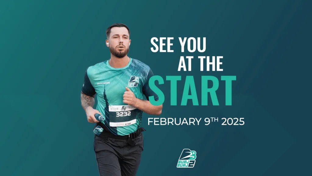A man running in a race wearing a teal athletic outfit with a race number 3232 and holding a water bottle, accompanied by text reading "See You at the Start, February 9th, 2025" on a teal background.