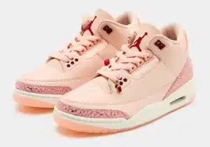 Pair of light pink high-top sneakers with red accents and textured pink details on the toe and heel.