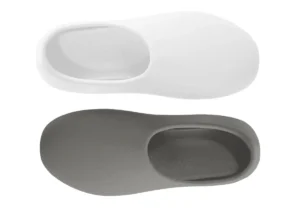 Pair of slip-on shoes, one white and one gray, with rounded edges and a minimalist design.