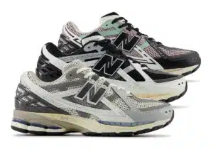 Three pairs of New Balance 1906R sneakers in different colorways: one in black, pink, and mint; another in white, black, and gray; and the last in white and light gray. All pairs feature a mesh upper and the New Balance logo prominently displayed.
