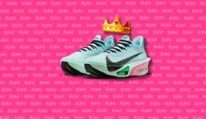 A pair of light blue Nike running shoes with a black swoosh logo, featuring a pink and green sole, placed on a vibrant pink background covered with repeated text that reads "RUN!" in a bold font. A golden crown is positioned above the shoes.
