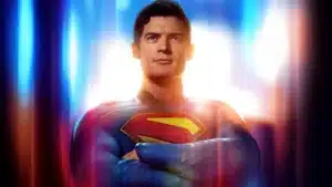 A superhero in a blue costume with a prominent red and yellow 'S' emblem on the chest, confidently standing with arms crossed against a bright, colorful background that suggests a strong, uplifting presence.
