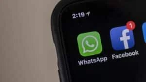 Close-up of a smartphone screen showing the WhatsApp and Facebook app icons, with a clock displaying the time as 2:19.