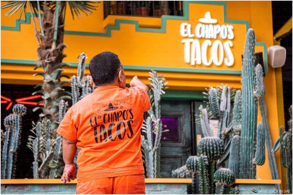 A person wearing an orange outfit with