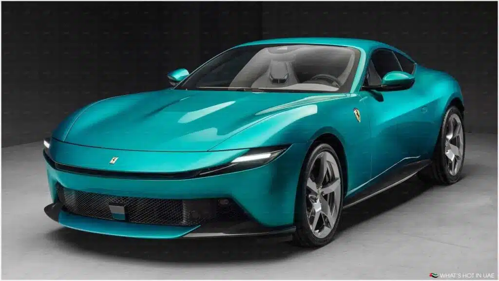 A sleek, turquoise sports car with a modern design, featuring sharp lines and a low profile, displayed in a showroom setting.