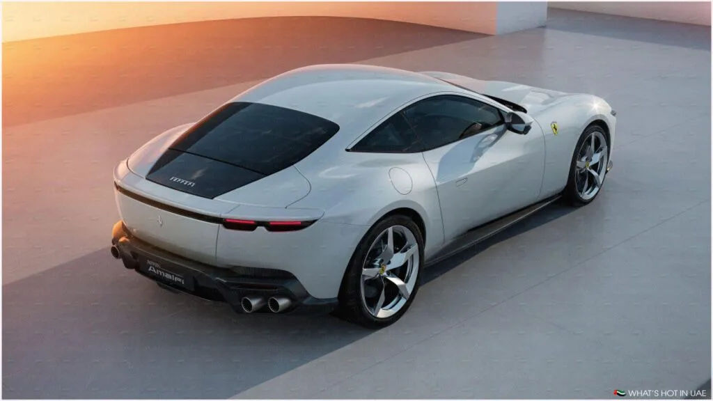 A sleek white sports car with a distinctive rear design and dual exhaust pipes, parked on a smooth surface at sunset.