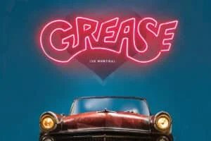 The promotional poster for 'Grease: The Musical', featuring the title 'GREASE' in neon pink lettering above a vintage convertible car with a red leather interior, set against a blue background with a heart shape.