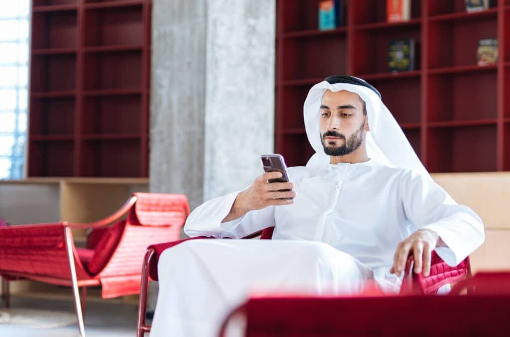 handsome man with traditional clothes working in an office of Du