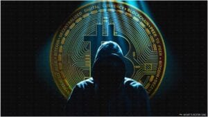 A hooded figure is silhouetted against the background of a large Bitcoin symbol and circuitry, suggestive of digital currency themes.
