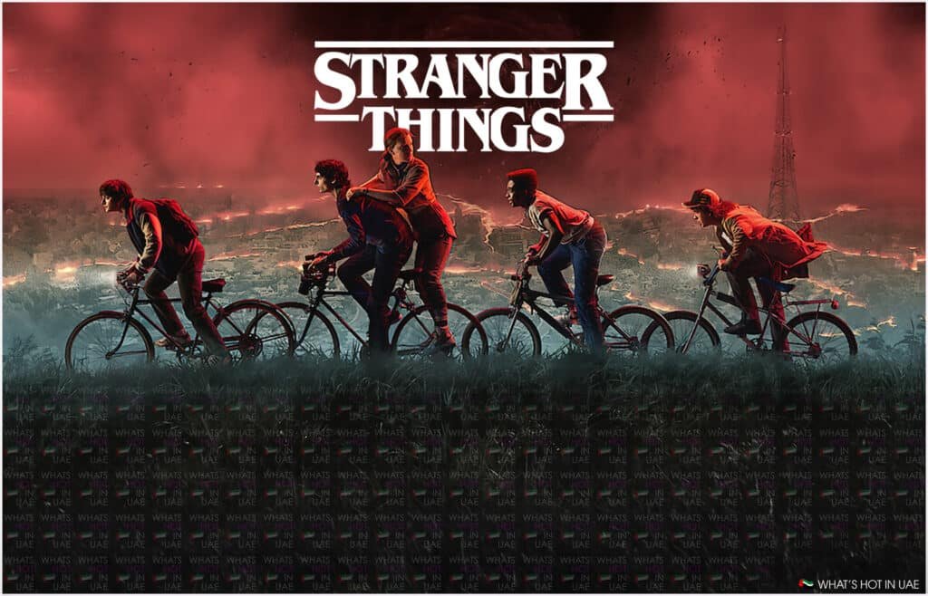 Promotional poster for 'Stranger Things' featuring four silhouetted figures riding bicycles against a red-tinted sky with lightning.