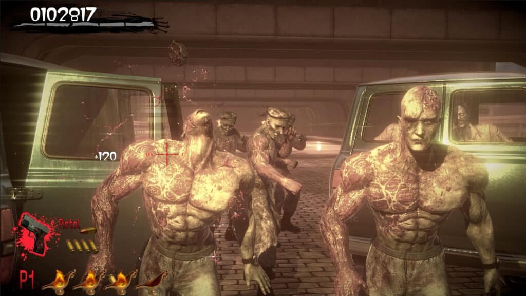 A video game scene featuring muscular zombies emerging from vans in a dark, underpass environment. The score of 0102817 is displayed at the top, with a red crosshair aiming at one zombie. The game interface shows a player's pistol and ammunition in the lower left corner.