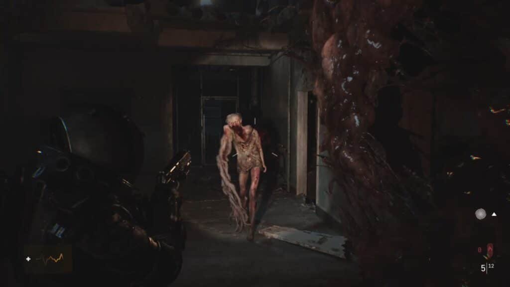 A dark, eerie corridor where an armored figure armed with a gun confronts a grotesque humanoid creature with an elongated arm and bloodied body.