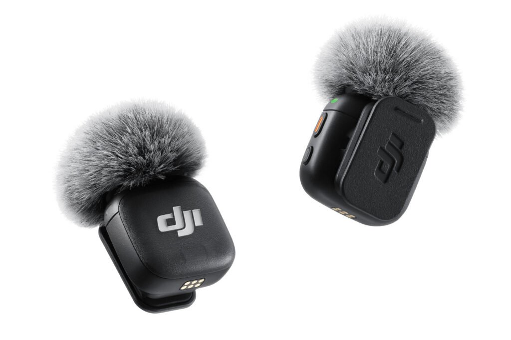 Two black wireless microphones with gray furry windshields, each featuring the DJI logo.