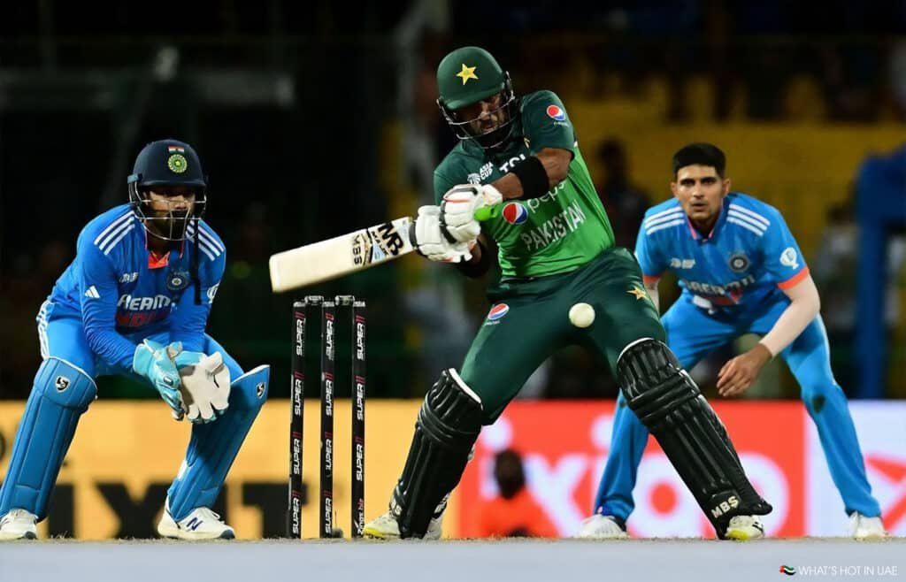 A cricket player from Pakistan is batting while a player from India is wicket-keeping during a match.
