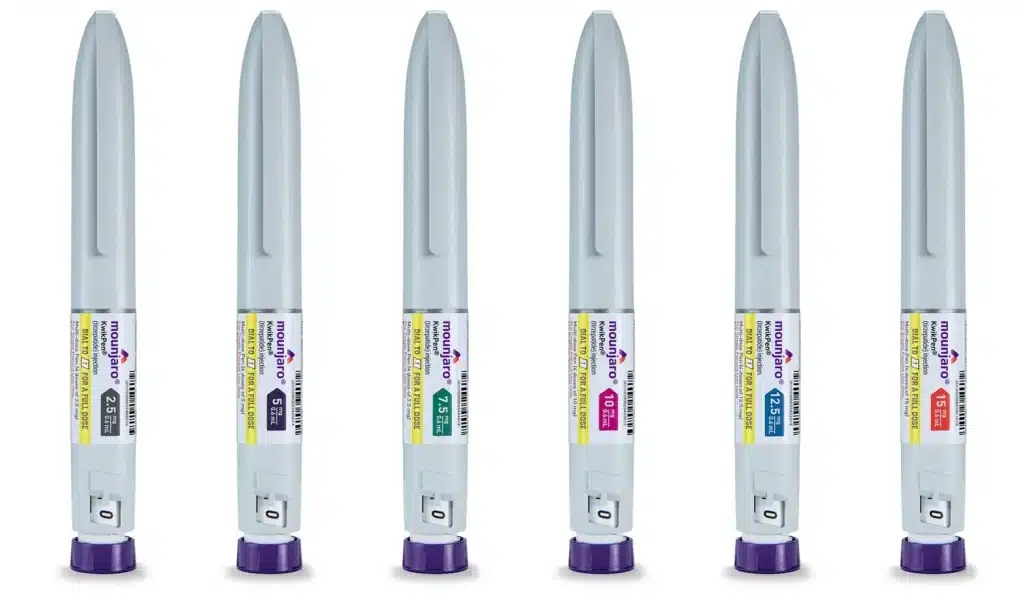 Six gray injectable pens with purple caps labeled "Mounjaro," each indicating different dosage strengths ranging from 2.5 mg to 15 mg.