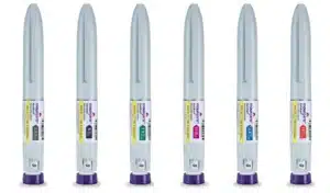 Six gray injectable pens with purple caps labeled "Mounjaro," each indicating different dosage strengths ranging from 2.5 mg to 15 mg.