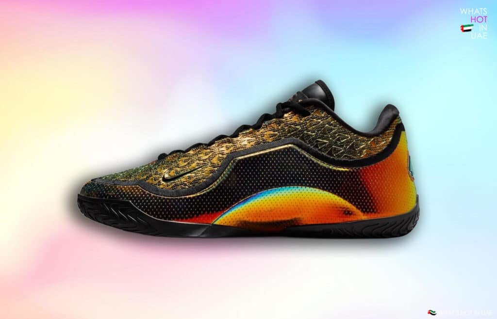 A colorful sneaker with a textured pattern, featuring a mix of orange, yellow, and black hues, set against a pastel gradient background.