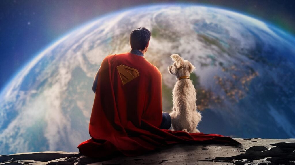 Superman in a red cape and a furry white dog sit on a rocky surface, looking at Earth from space.